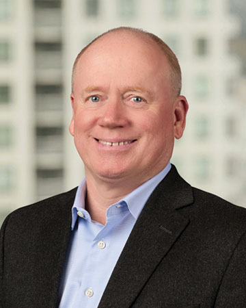 a man in a suit smiling