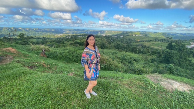 Lady standing in front of landscape